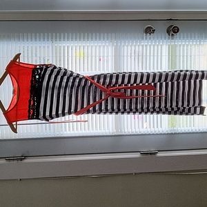 Sleeveless black and white striped dress with belt